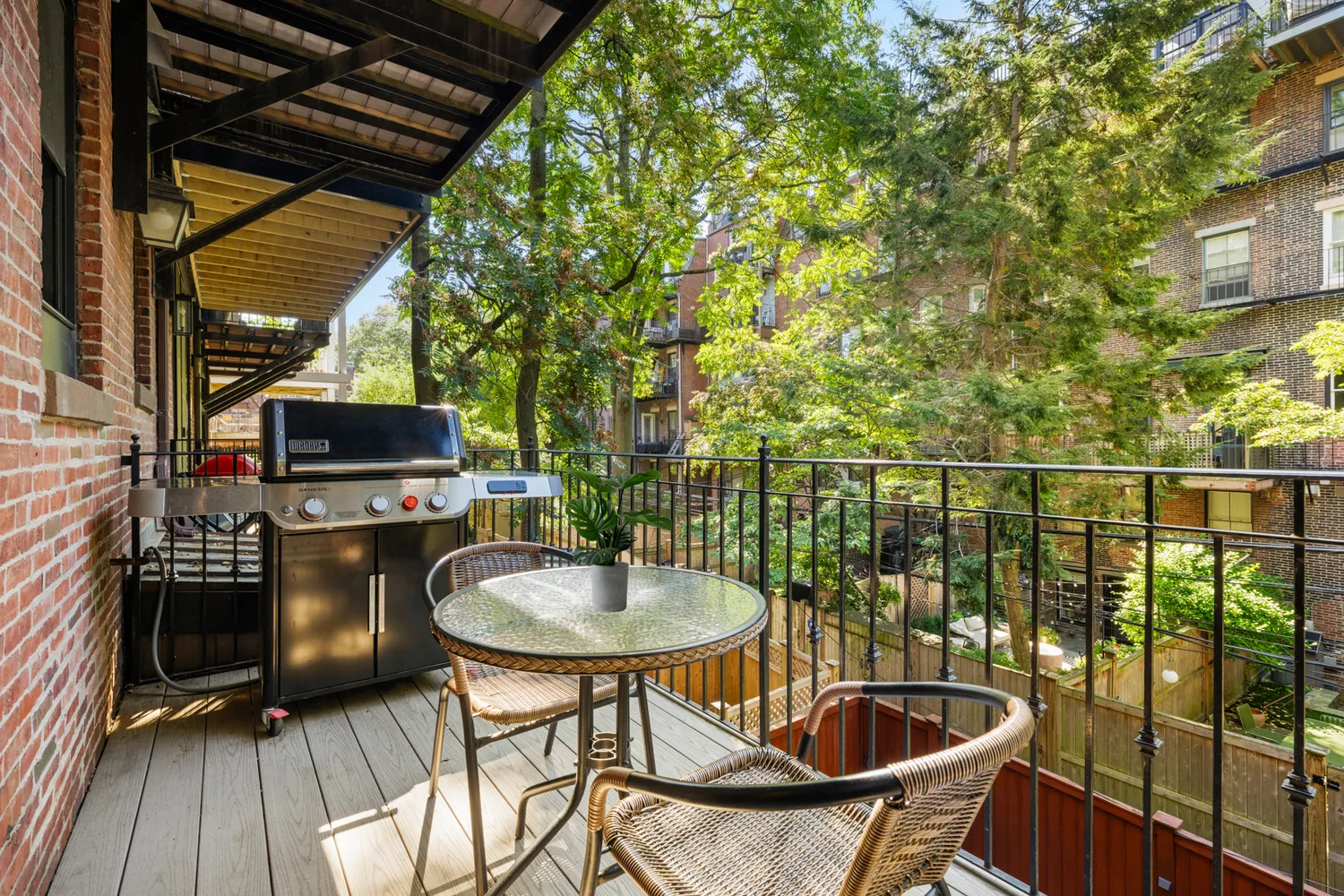 a view of a balcony with chairs and table in the patio