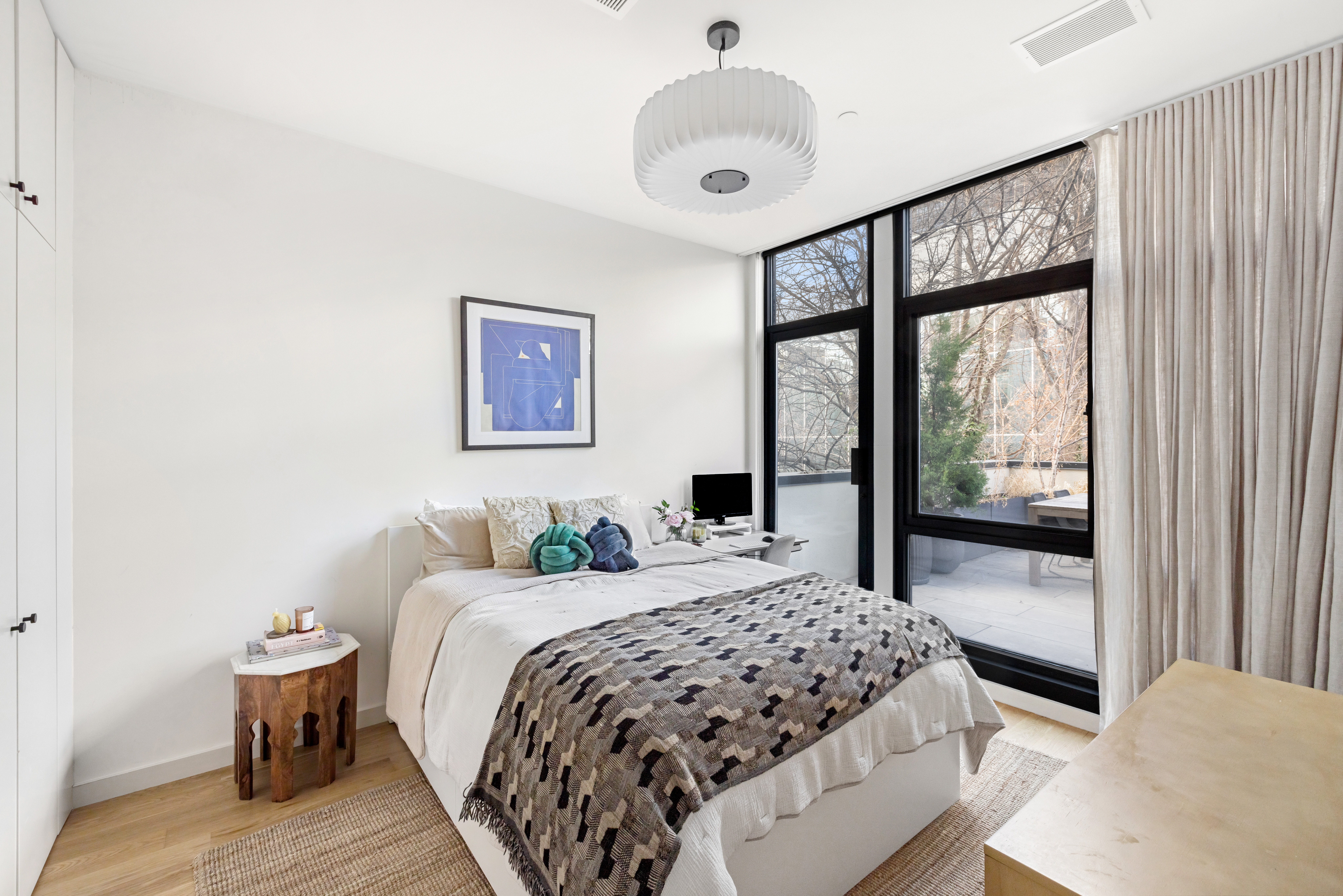 735 Dean Street, Unit 2B Brooklyn, NY 11238 - Photo 7 of 11 a bedroom with a large bed and a large window