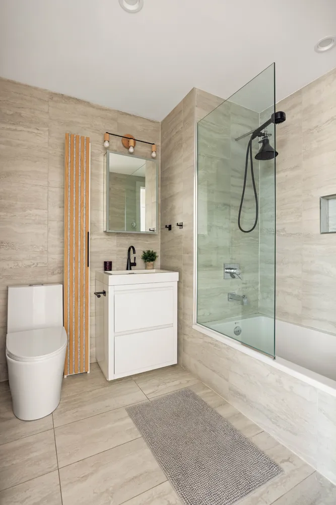 a bathroom with a sink toilet and shower