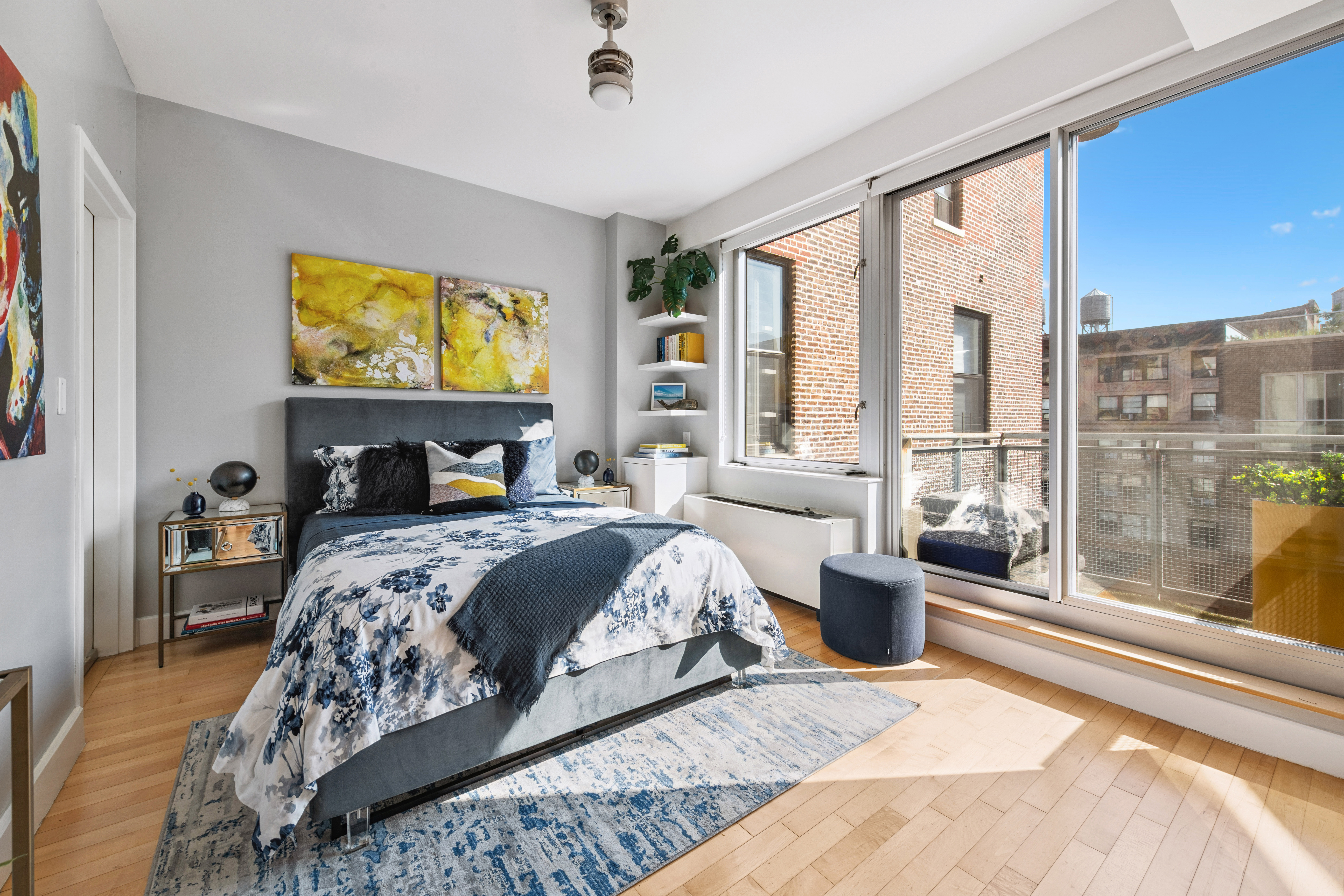 146-148 West 22nd Street, Unit PH Manhattan, NY 10011 - Photo 6 of 13 a bedroom with a large bed and a large window