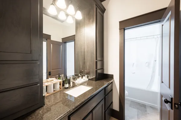 a large kitchen with stainless steel appliances granite countertop a stove and a refrigerator