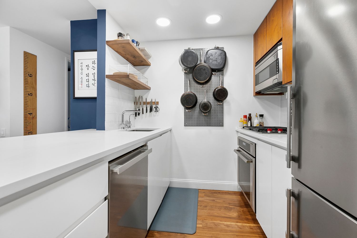 515 East 72nd Street, Unit 9J Manhattan, NY 10021 - Photo 2 of 17 a kitchen with a refrigerator and a stove