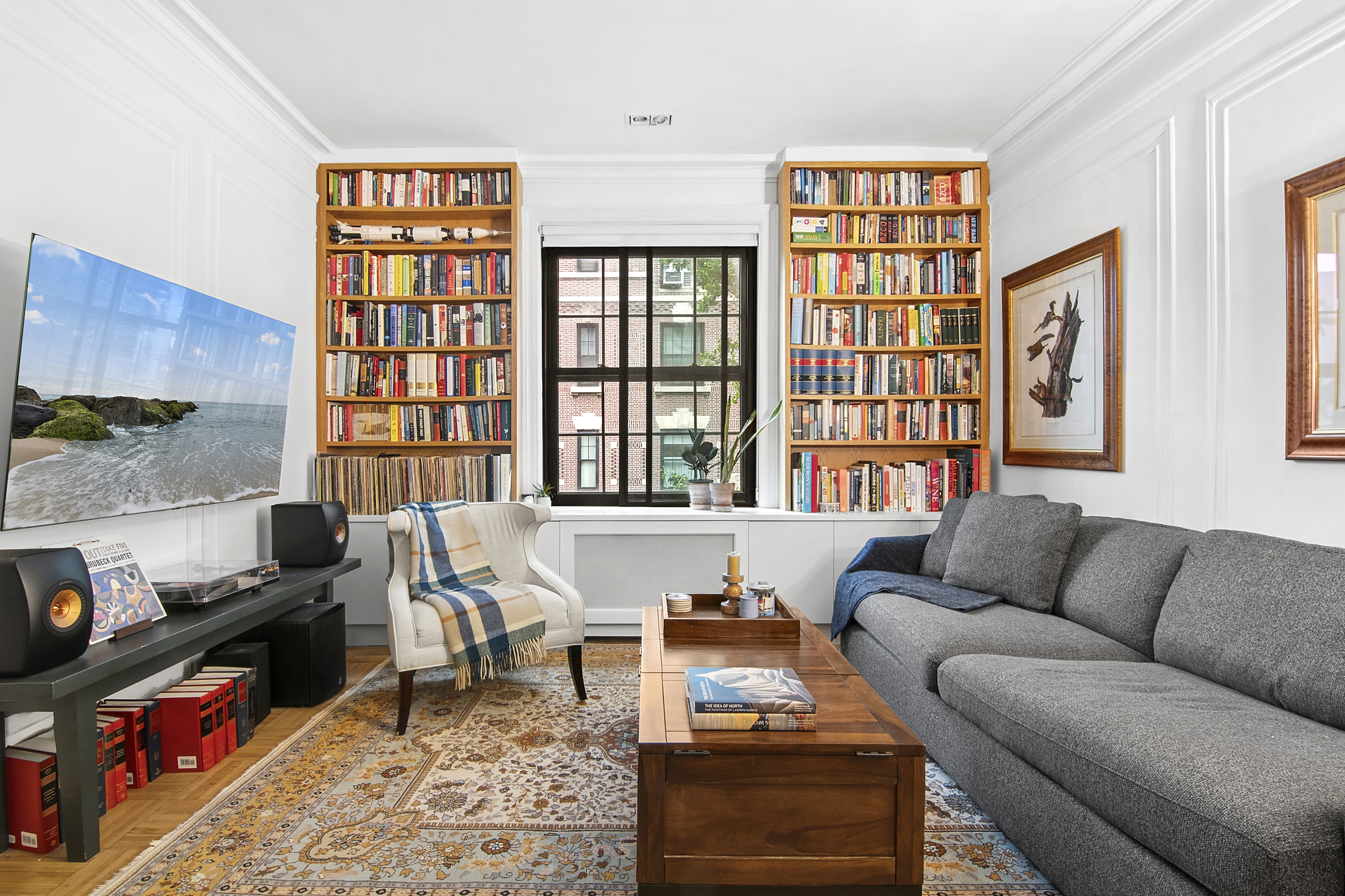 205 Hicks Street, Unit 2B Brooklyn, NY 11201 - Photo 2 of 8 a living room with furniture a bookshelf and a window