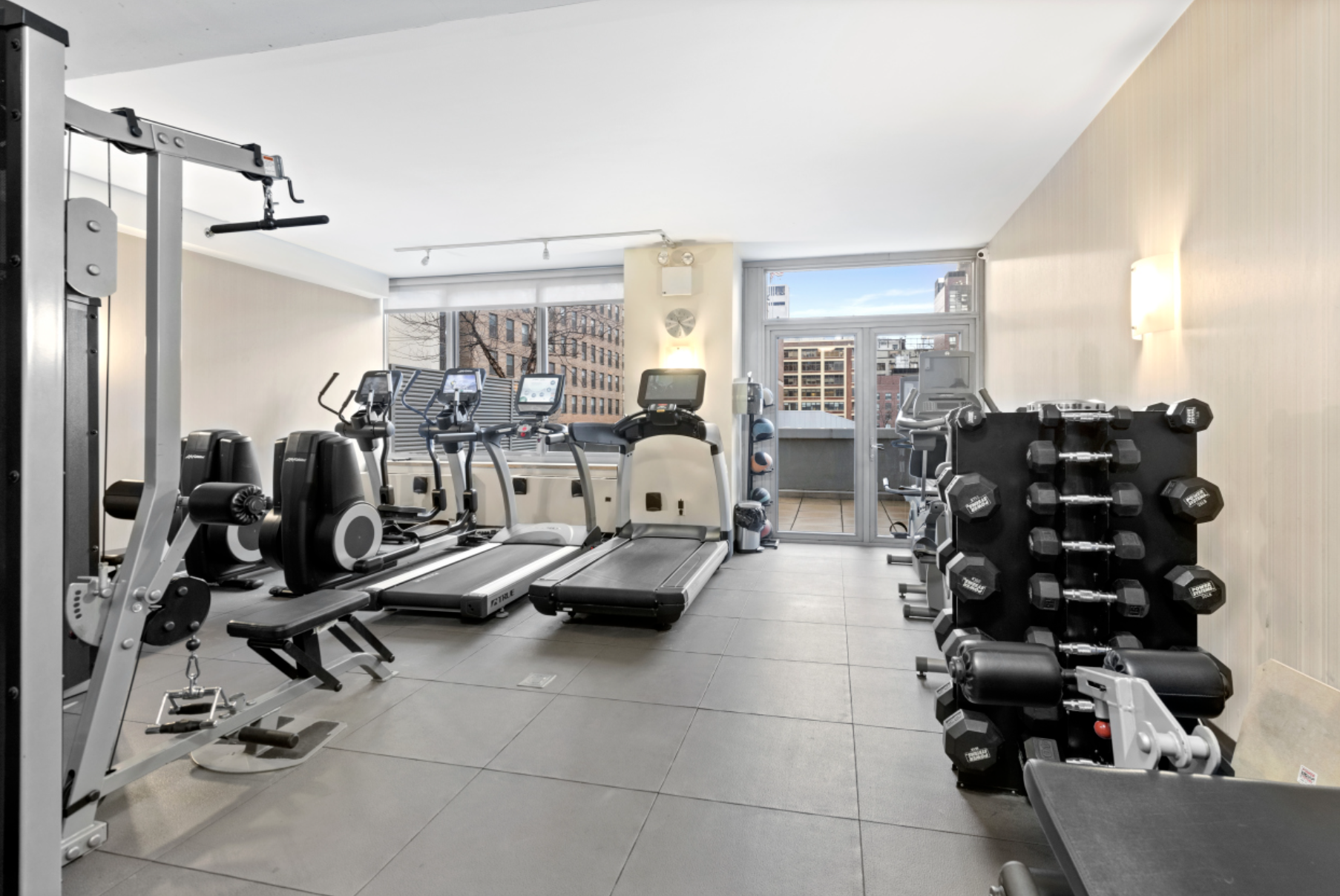 225 West 60th Street, Unit 8F Manhattan, NY 10023 - Photo 9 of 11 a view of a room with gym equipment
