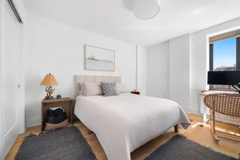 a bedroom with a bed and a chair