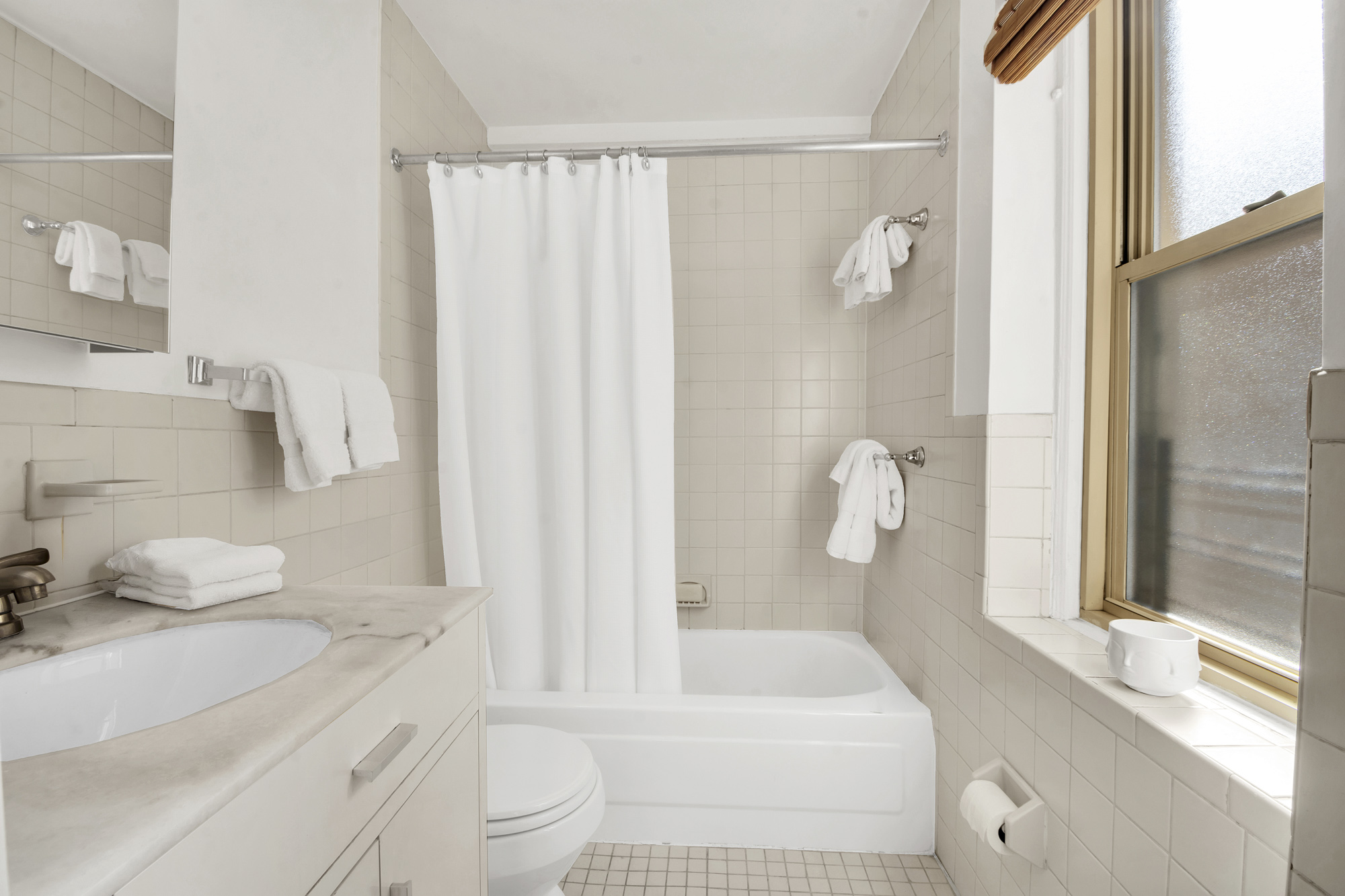 59 West 12th Street, Unit 6A Manhattan, NY 10011 - Photo 9 of 11 a bathroom with a sink a toilet and shower