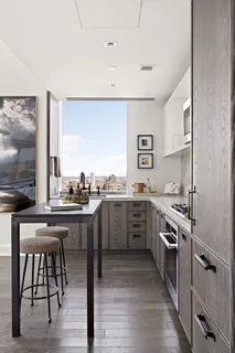a kitchen with a sink appliances and cabinets