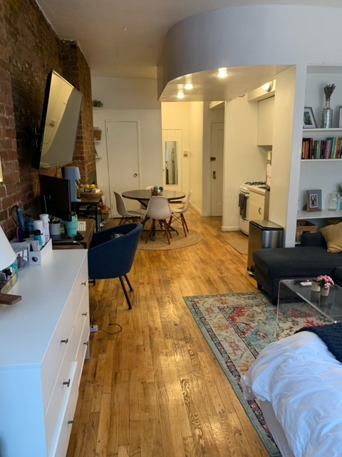143 Sullivan Street, Unit 12 Manhattan, NY 10012 - Photo 7 of 11 a living room with furniture and a mirror