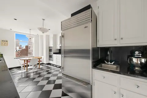a kitchen with stainless steel appliances granite countertop a refrigerator and a sink