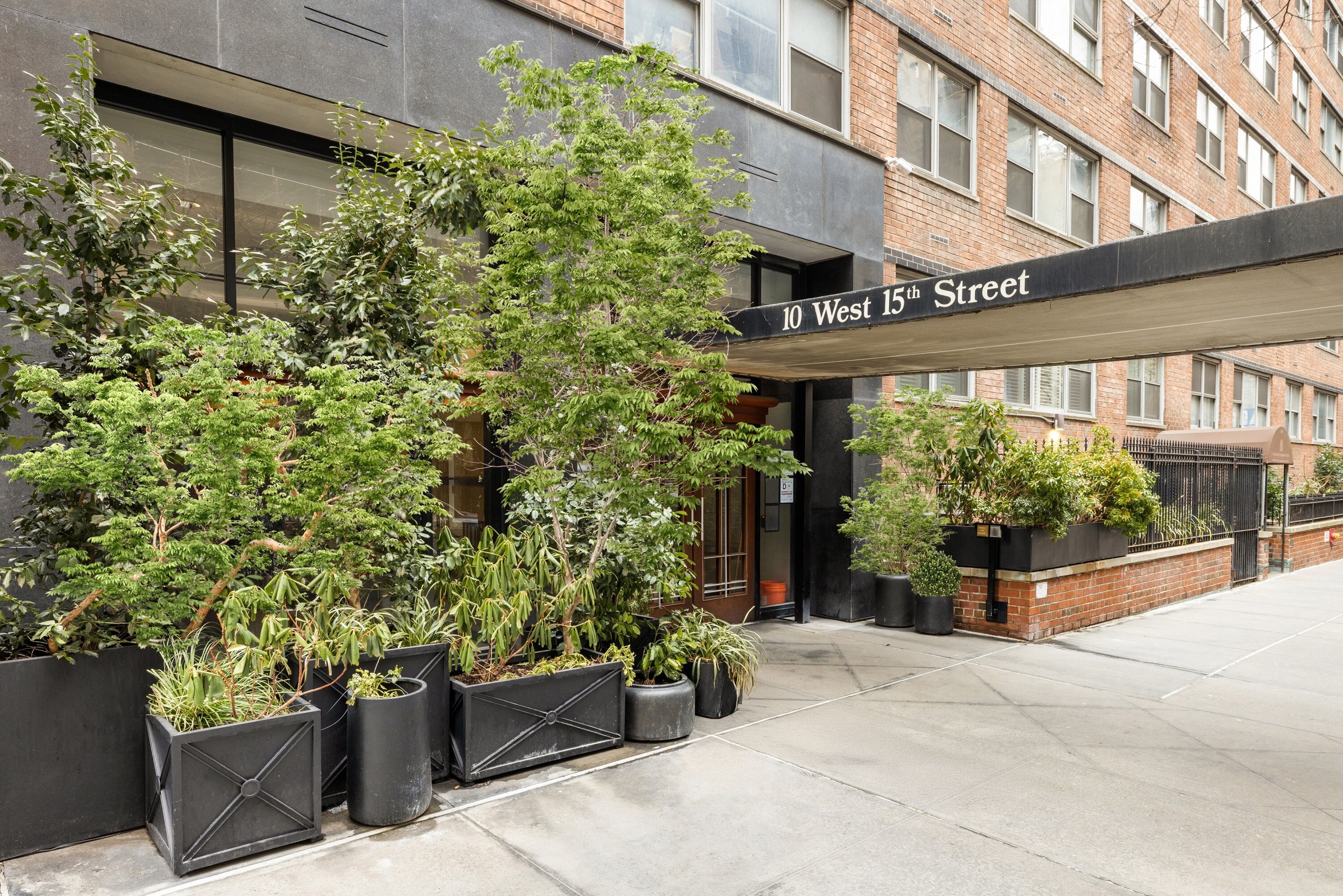 10 West 15th Street, Unit 1721 Manhattan, NY 10011 - Photo 8 of 10 front view of a house with potted plants
