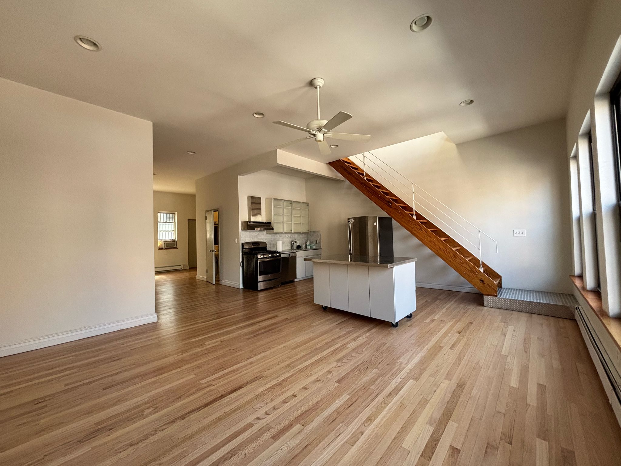 85 Division Street, Unit 4 Manhattan, NY 10002 - Photo 16 of 22 a living room with furniture and a wooden floor