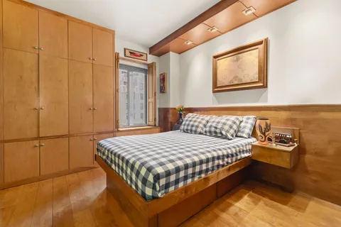 a bedroom with a bed and cabinets