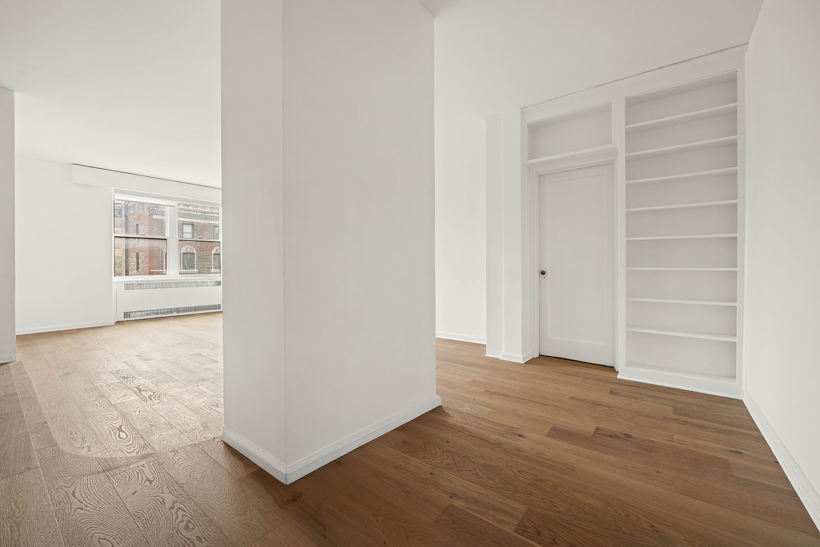 263 West End Avenue, Unit 13F Manhattan, NY 10023 - Photo 10 of 22 an empty room with wooden floor cabinet and windows