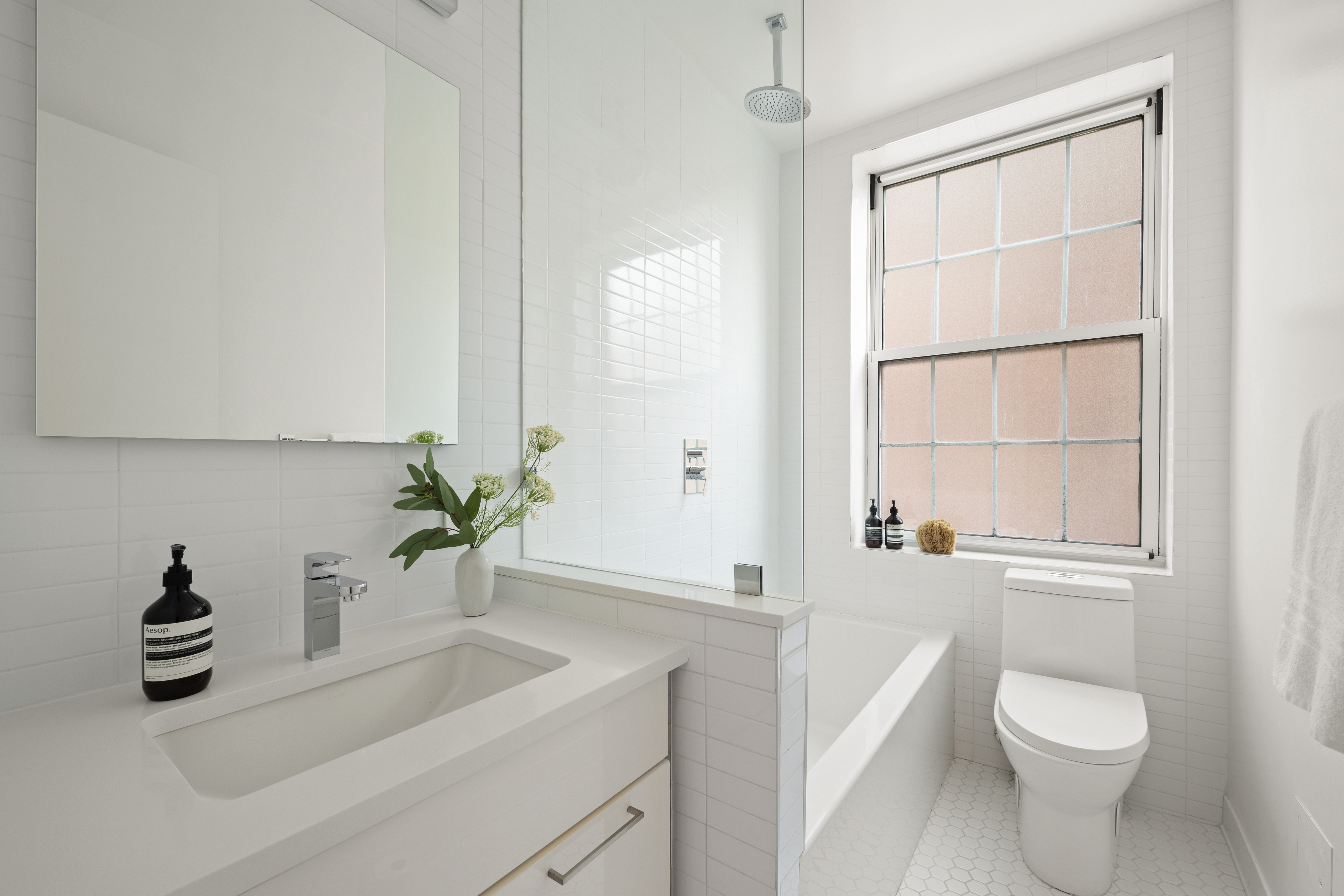 41 5th Avenue, Unit 8CN Manhattan, NY 10003 - Photo 8 of 11 a bathroom with a toilet a sink and a window