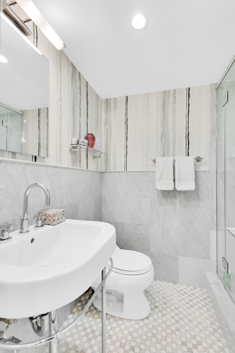 150 East 69th Street, Unit 8J Manhattan, NY 10021 - Photo 9 of 13 a bathroom with a sink mirror and toilet
