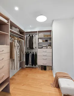 a view of walk in closet with clothes