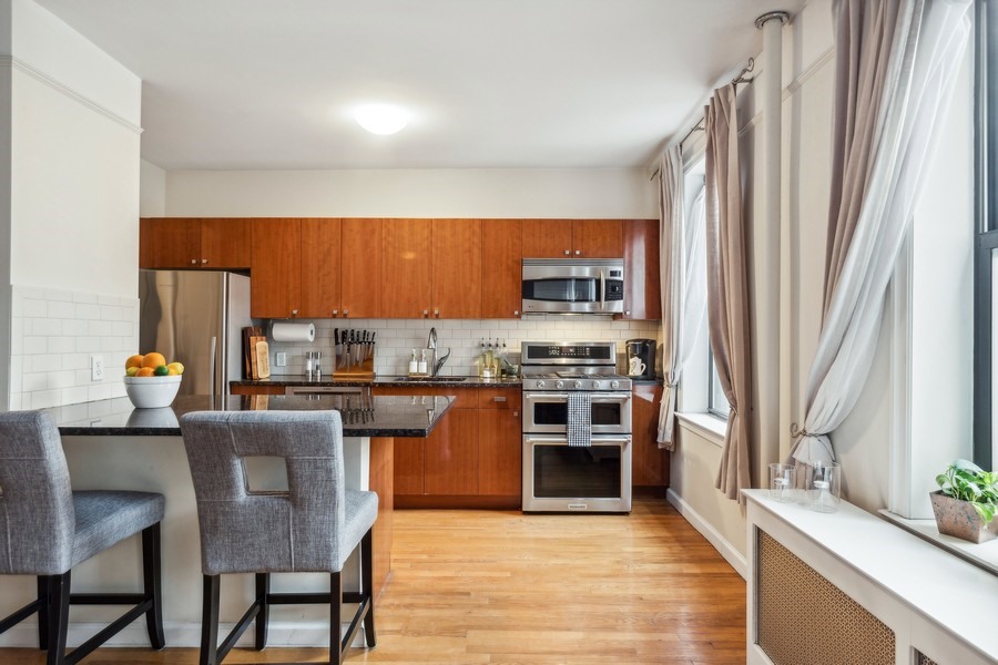 779 Riverside Drive, Unit C31 Manhattan, NY 10032 - Photo 5 of 13 a kitchen with stainless steel appliances granite countertop a stove top oven a sink and dishwasher