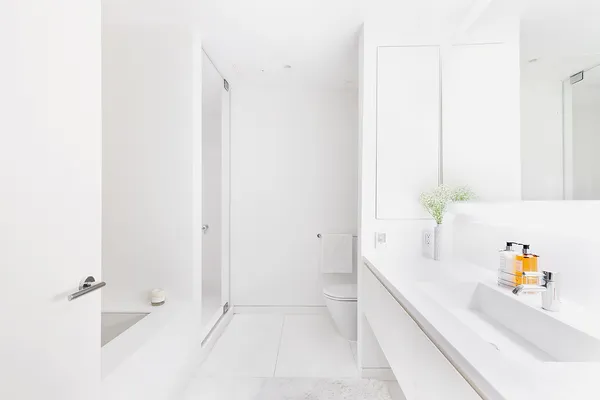 a bathroom with a bathtub sink and mirror