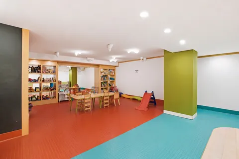 a living room with furniture and a pool table