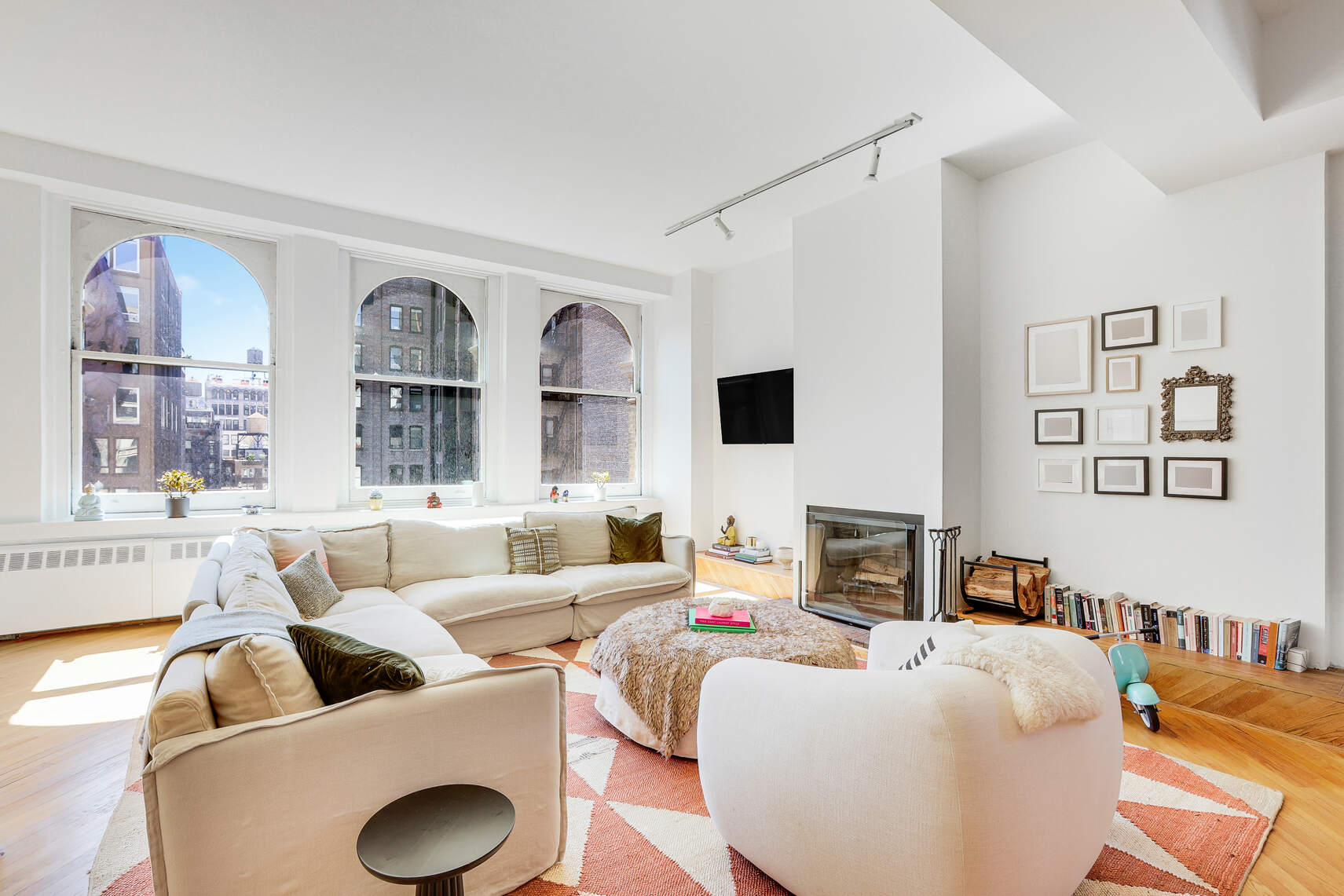 35 East 12th Street, Unit 8C Manhattan, NY 10003 - Photo 4 of 22 a living room with furniture and a flat screen tv