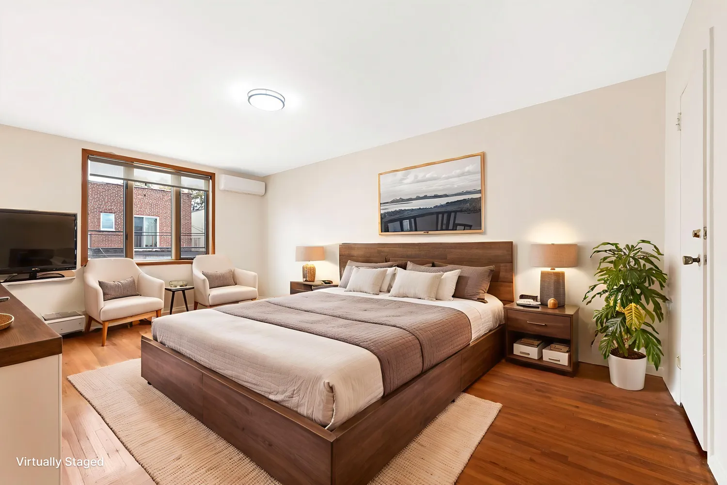 a bedroom with a large bed and a flat screen tv