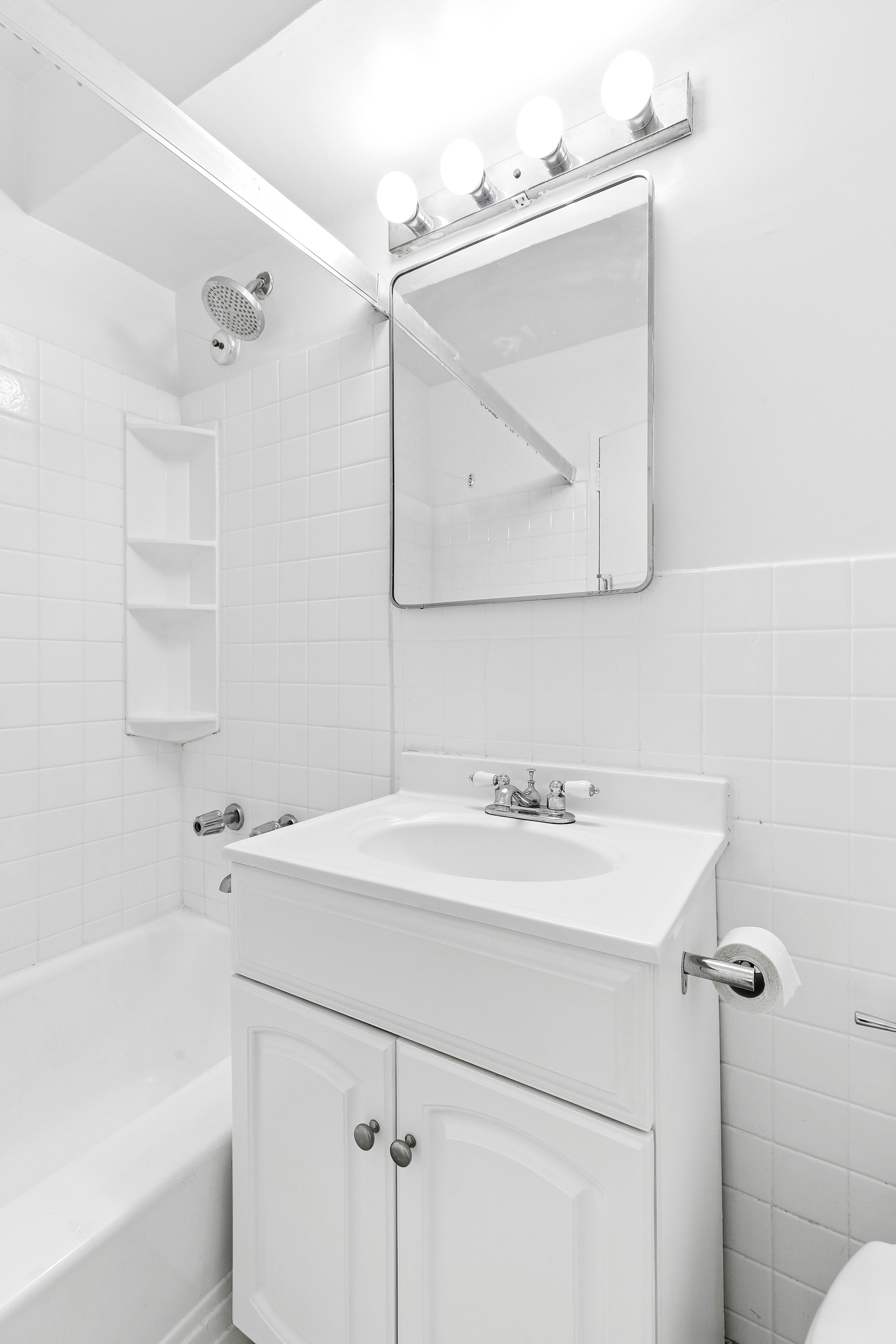 411 East 57th Street, Unit 14F Manhattan, NY 10022 - Photo 5 of 8 a bathroom with a sink vanity and a mirror