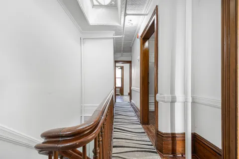 a balcony view with wooden floor and staircase