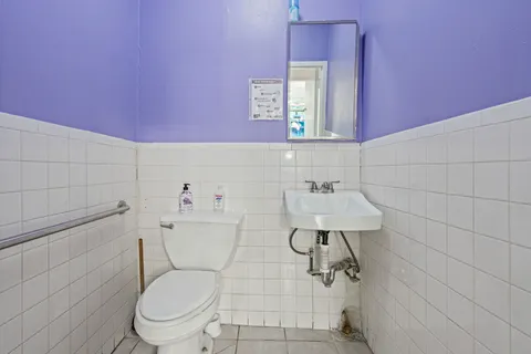 a white toilet sitting next to a bathroom sink