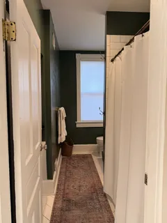 a hallway with sliding door and stairs