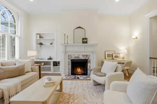 a living room with furniture and a fireplace