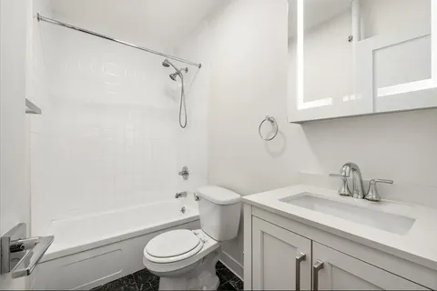a bathroom with a sink a toilet and a mirror