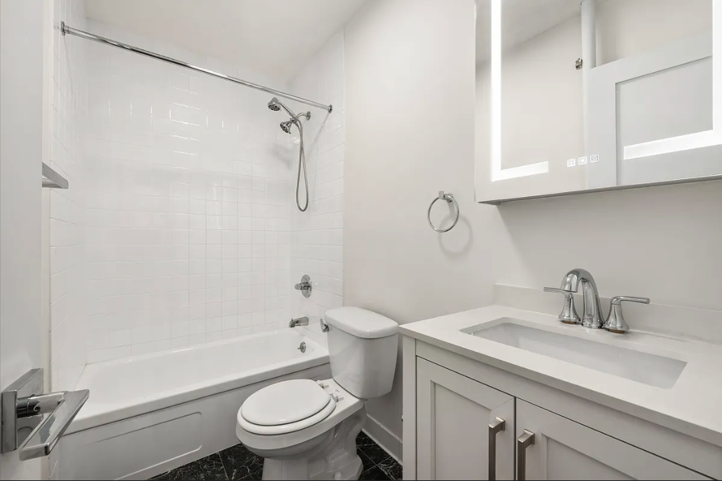 130 West 80th Street, Unit 4F Manhattan, NY 10024 - Photo 5 of 7 a bathroom with a sink a toilet and a mirror