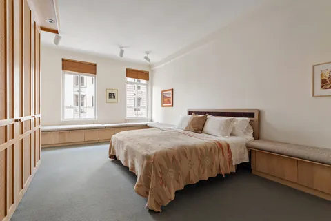 a spacious bedroom with a bed and a window