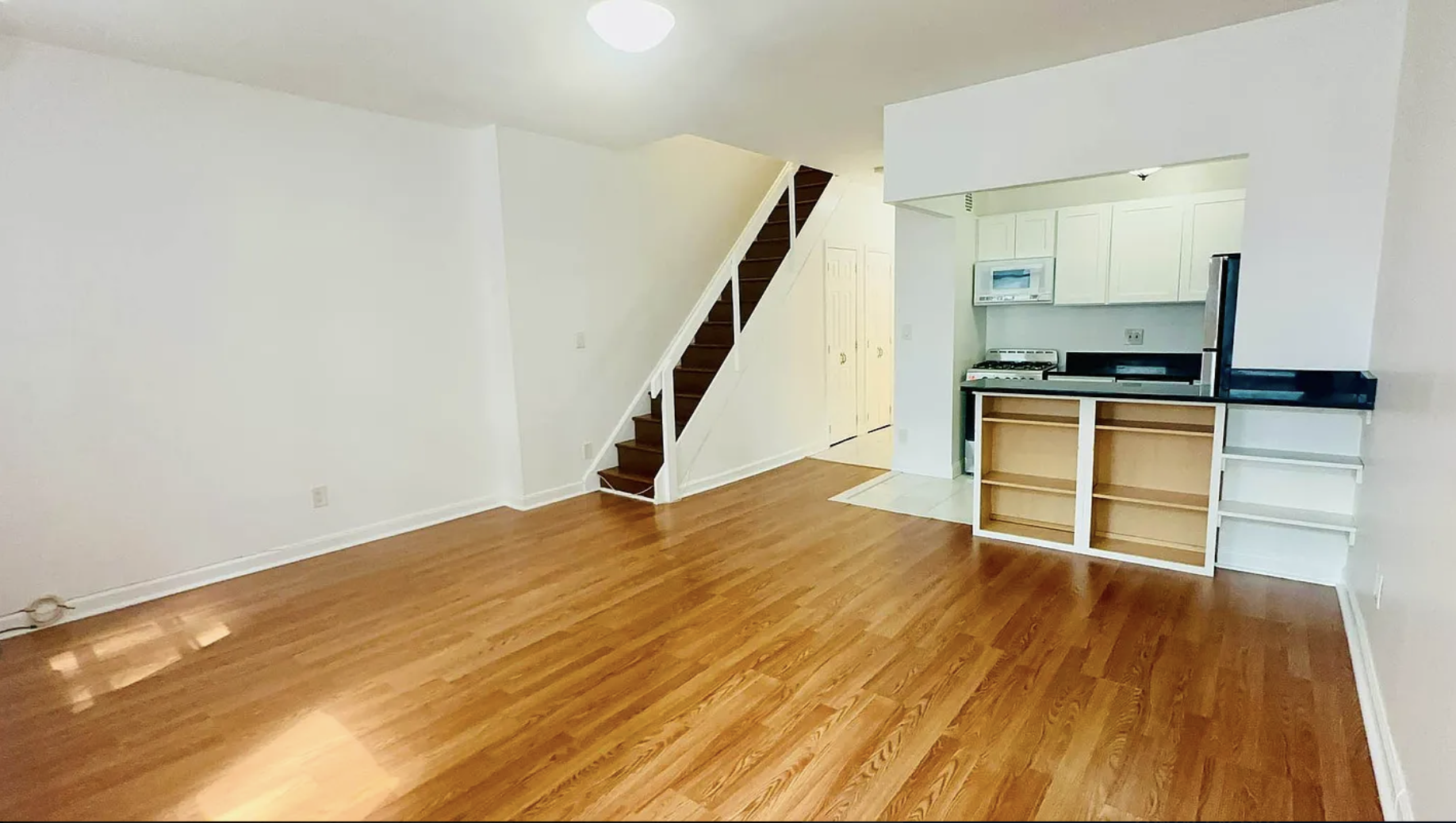 305 East 95th Street, Unit 6E Manhattan, NY 10128 - Photo 3 of 9 a view of a kitchen with wooden floor and electronic appliances