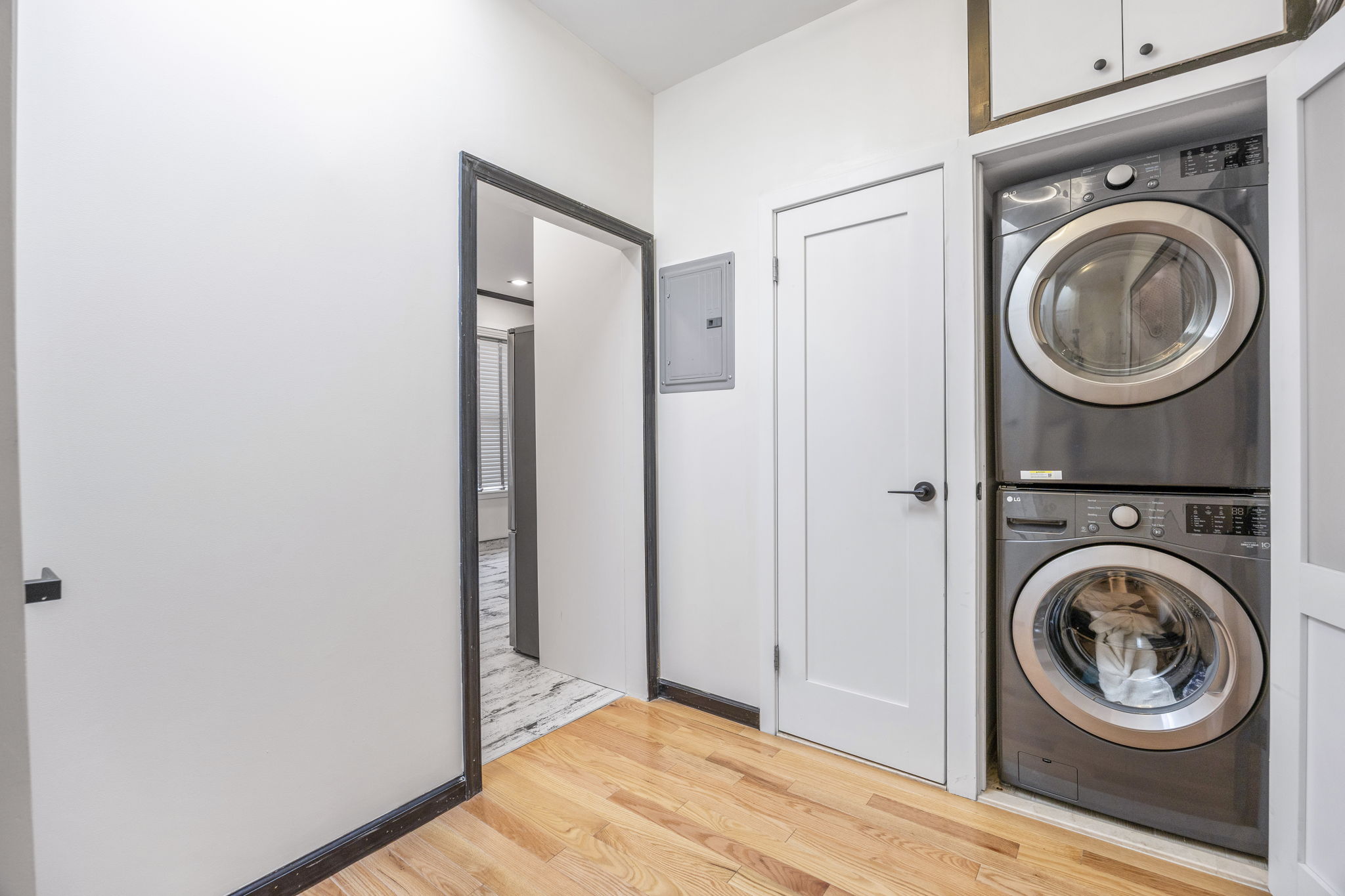25-69 46th Street Queens, NY 11103 - Photo 10 of 33 a view of a hallway with washer and dryer