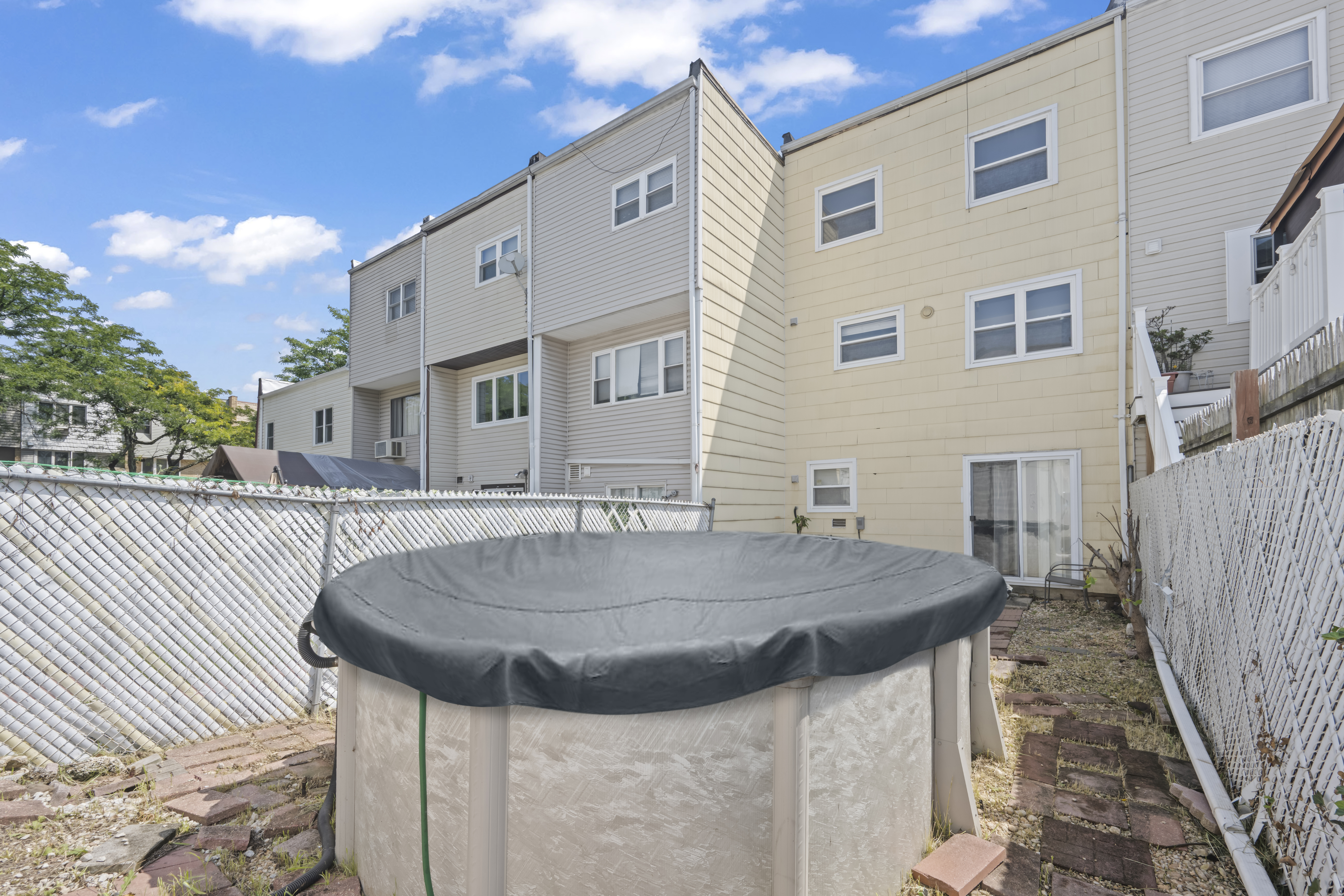 12 Yucca Drive Staten Island, NY 10312 - Photo 20 of 21 a backyard of a house with table and chairs