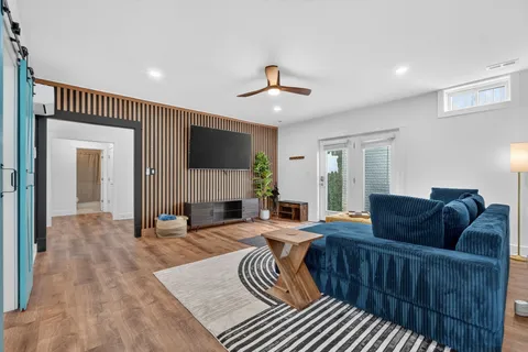 a living room with furniture a ceiling fan and a rug