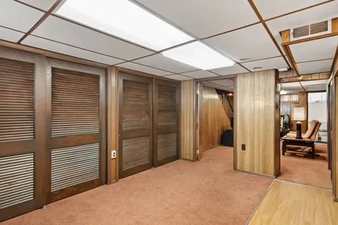 a view of a hallway with wooden shelves