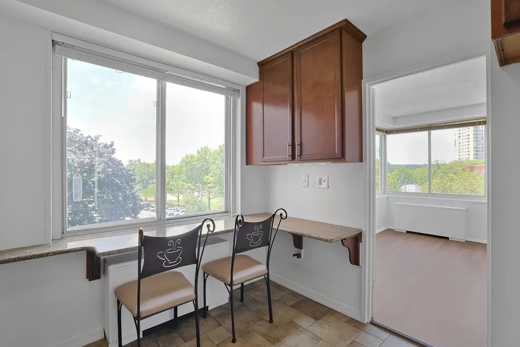a dining room with furniture and a window