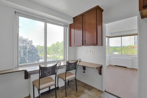 a dining room with furniture and a window