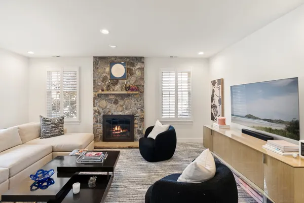 a large bed sitting in a bedroom next to a window and a dresser