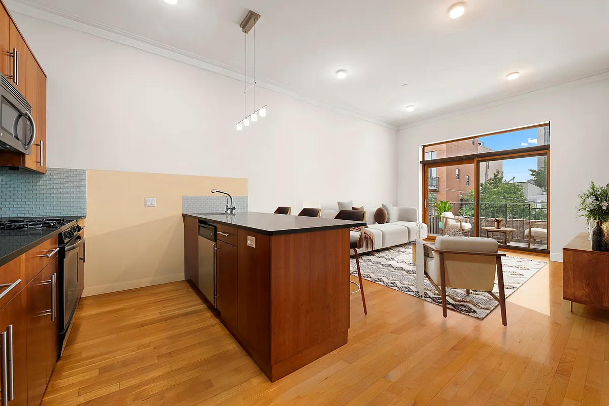 206 Kent Street, Unit 6 Brooklyn, NY 11222 - Photo 4 of 9 a living room with furniture and a large window