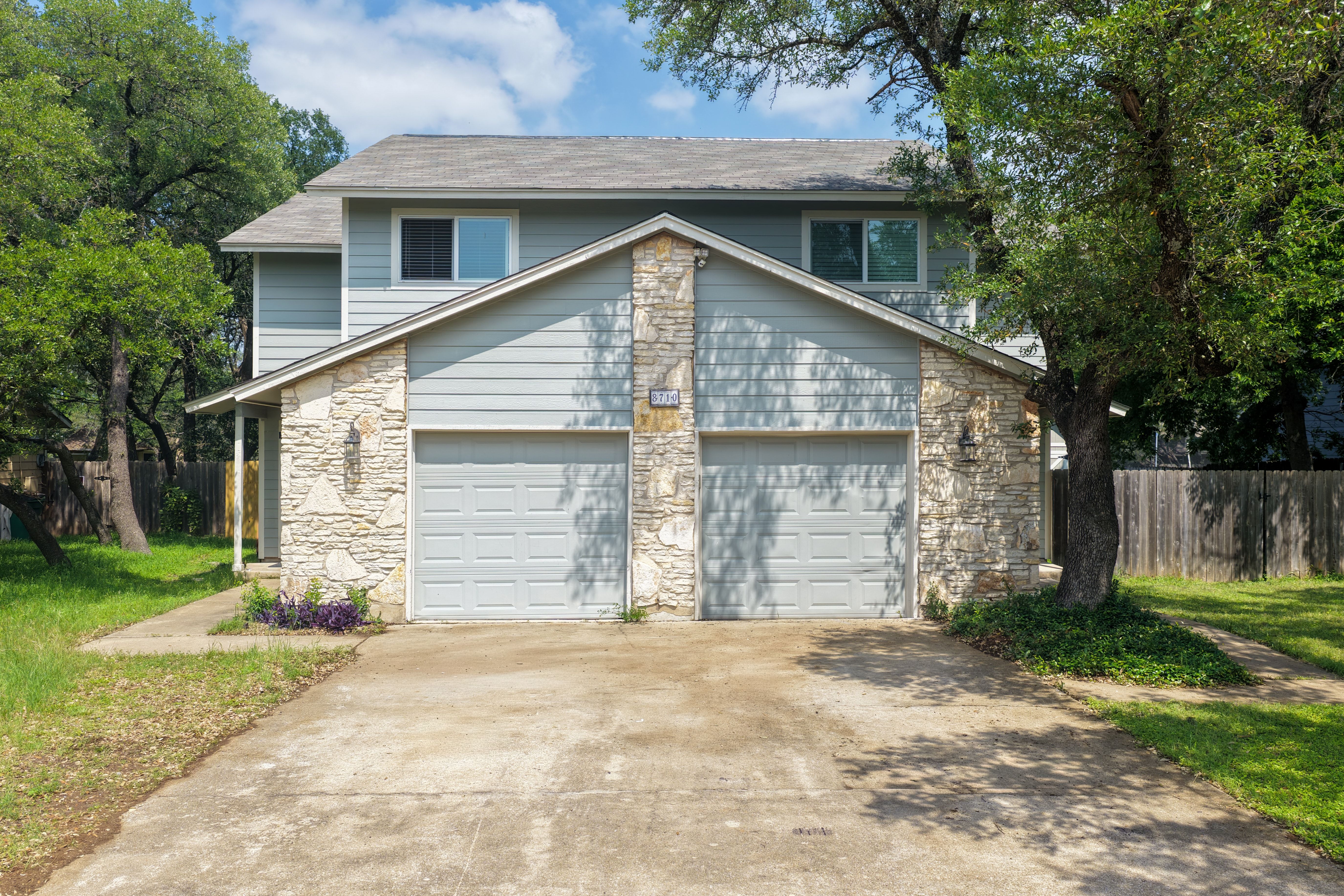 8710 Clearbrook Trail Austin, TX 78729 - Photo 2 of 28 a front view of a house with a yard and garage