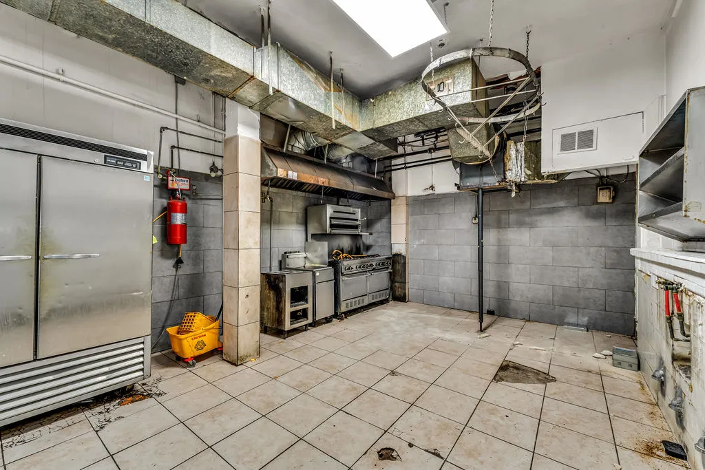 a kitchen with granite countertop a stove and a microwave