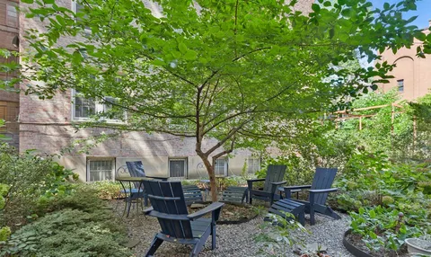 a view of a chairs and table in a backyard