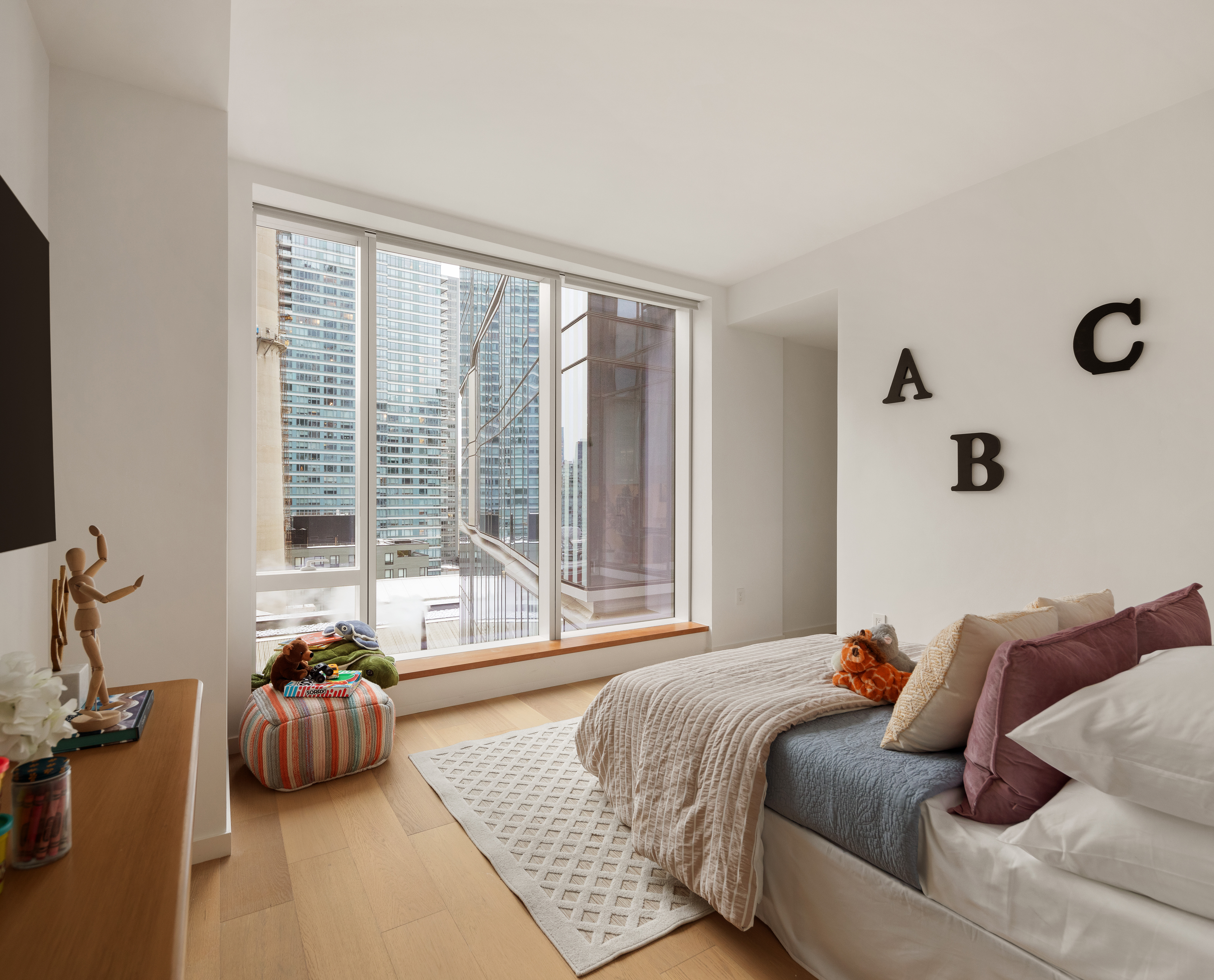 1 West End Avenue, Unit 12D Manhattan, NY 10023 - Photo 11 of 32 a bedroom with furniture and a large window