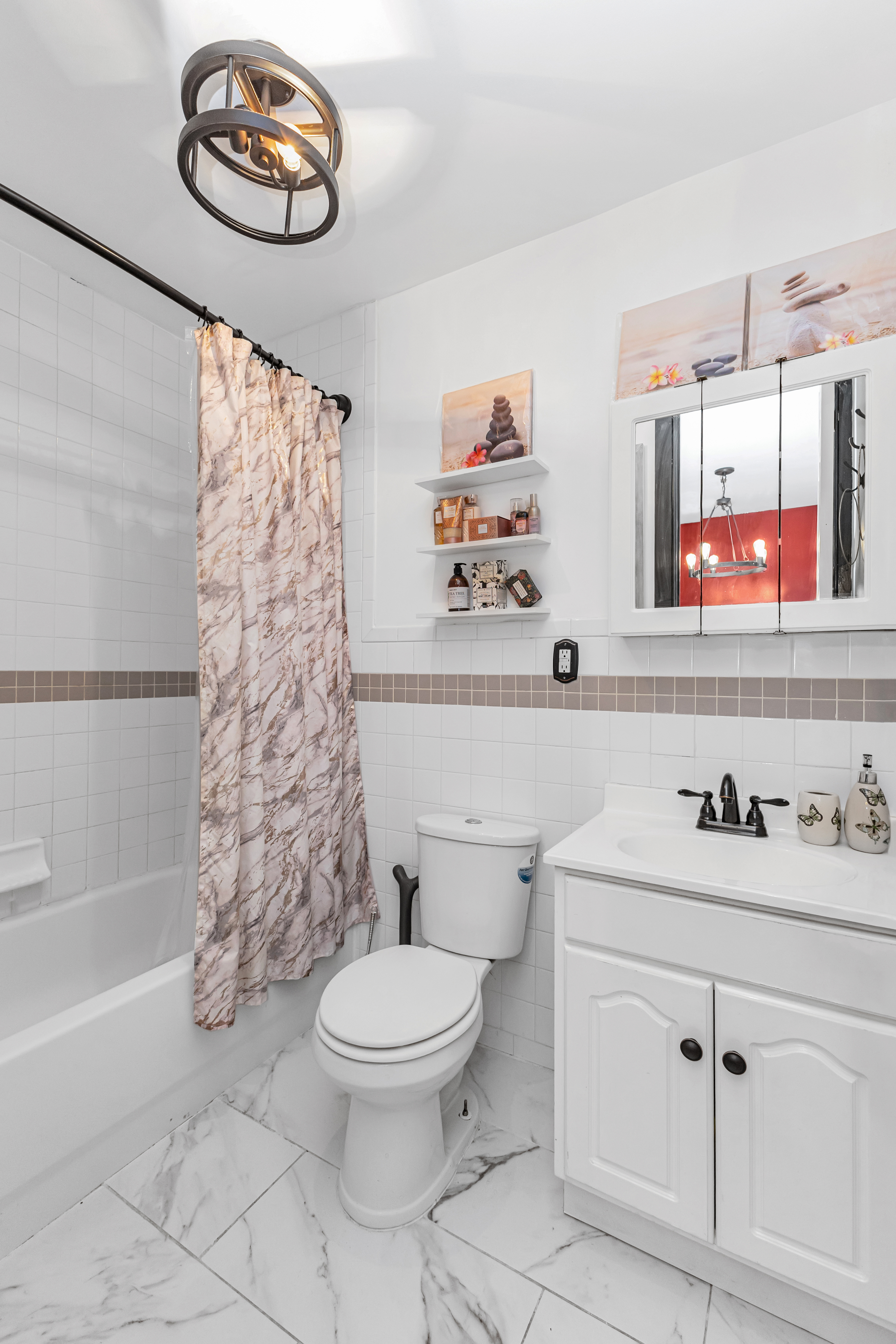 786 Madison Street, Unit 3B Brooklyn, NY 11221 - Photo 8 of 11 a bathroom with a sink a toilet and a shower curtain