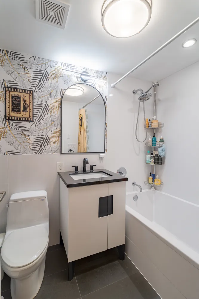 a bathroom with a sink a toilet and mirror