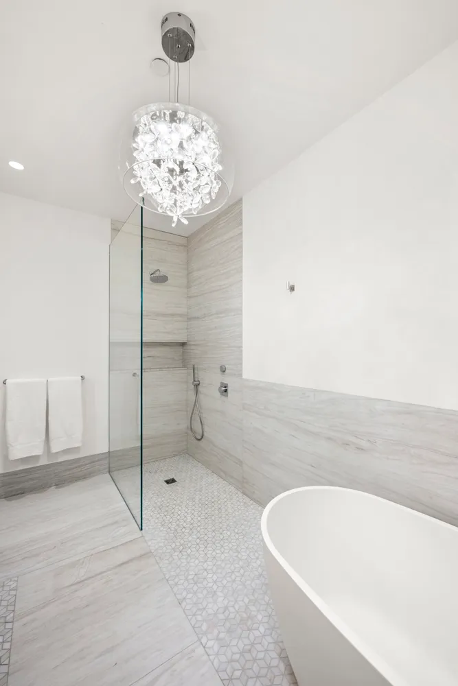 a bathroom with a bathtub and a shower