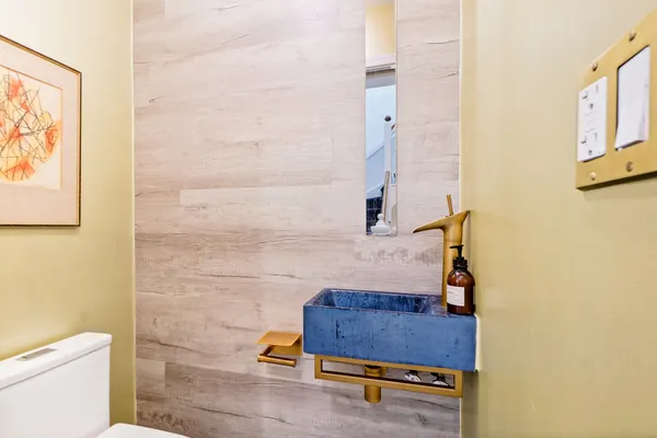 a bathroom with a toilet and a mirror